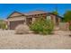 Single-story home features a two-car garage, desert landscaping, and a concrete driveway at 205 N 107Th Dr, Avondale, AZ 85323