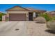 Charming single-story home with a two-car garage and low-maintenance desert landscaping at 205 N 107Th Dr, Avondale, AZ 85323