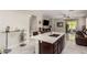 Open concept kitchen with island, tile flooring, granite countertops and adjacent to living area at 205 N 107Th Dr, Avondale, AZ 85323