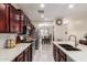 Bright kitchen with granite countertops, stainless steel appliances, tile flooring, and seamless flow to dining area at 205 N 107Th Dr, Avondale, AZ 85323