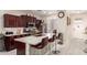 This kitchen boasts a central island with bar stool seating, granite counters, and stainless steel appliances at 205 N 107Th Dr, Avondale, AZ 85323