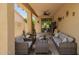 Inviting covered patio with comfortable seating, ceiling fan and easy access to the indoors at 205 N 107Th Dr, Avondale, AZ 85323
