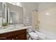Bright bathroom features a vanity with a sink, toilet, and bathtub with shower at 20814 N Dries Rd, Maricopa, AZ 85138
