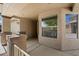 Inviting front porch featuring stylish pillars, stucco walls, and large windows at 20814 N Dries Rd, Maricopa, AZ 85138