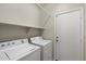 Functional laundry room with white washer and dryer, offering convenience and efficiency at 20814 N Dries Rd, Maricopa, AZ 85138
