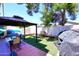 Enjoy outdoor living in this backyard featuring a covered patio with dining area and artificial turf at 2416 W Caribbean Ln # 2, Phoenix, AZ 85023