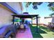 Relaxing backyard featuring a gazebo-covered patio with dining and green turf, perfect for outdoor living at 2416 W Caribbean Ln # 2, Phoenix, AZ 85023