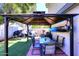The Backyard includes a shaded patio area with an outdoor dining set and low-maintenance artificial grass at 2416 W Caribbean Ln # 2, Phoenix, AZ 85023