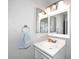 Bathroom with a white sink, a mirror, vanity lighting, a towel ring with a blue towel, and grey painted walls at 2416 W Caribbean Ln # 2, Phoenix, AZ 85023