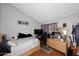 Bedroom with a double bed, hardwood floors, an open closet, a TV, grey walls, and a window with purple curtains at 2416 W Caribbean Ln # 2, Phoenix, AZ 85023