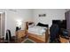 Bedroom with a double bed, hardwood floors, a wooden nightstand, a lamp, and a window with grey curtains at 2416 W Caribbean Ln # 2, Phoenix, AZ 85023