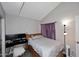 Bedroom with a double bed, vaulted ceiling, grey walls, purple curtains, and a desk with two monitors at 2416 W Caribbean Ln # 2, Phoenix, AZ 85023