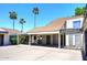 Attractive property with a covered parking area and desert landscaping, enhanced by tall palm trees at 2416 W Caribbean Ln # 2, Phoenix, AZ 85023