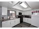 Modern kitchen with sleek white cabinets, black appliances, and stylish backsplash at 2416 W Caribbean Ln # 2, Phoenix, AZ 85023