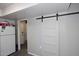 Bright kitchen featuring a refrigerator next to a barn-style door at 2416 W Caribbean Ln # 2, Phoenix, AZ 85023