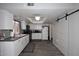 Bright kitchen featuring white cabinets, stainless steel appliances, and a barn-style sliding door at 2416 W Caribbean Ln # 2, Phoenix, AZ 85023