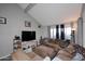 Comfortable living room with a plush sectional sofa, media center, and lots of natural light at 2416 W Caribbean Ln # 2, Phoenix, AZ 85023