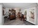 Cozy living room featuring a brick fireplace, wood flooring, and a curated display cabinet at 2416 W Caribbean Ln # 2, Phoenix, AZ 85023