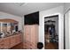 Spacious bedroom with a dresser, TV, and convenient access to a closet at 2416 W Caribbean Ln # 2, Phoenix, AZ 85023