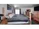 Comfortable main bedroom with four poster bed, wood floors, and natural lighting at 2416 W Caribbean Ln # 2, Phoenix, AZ 85023
