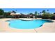Community pool area featuring a spacious pool, lounge chairs, and shaded seating for residents enjoyment at 2416 W Caribbean Ln # 2, Phoenix, AZ 85023