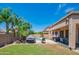 Spacious backyard showcasing a large pool, seating, manicured lawn, and privacy fence at 26072 N 74Th Ave, Peoria, AZ 85383