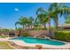 Lush tropical landscaping surrounds a relaxing pool area with comfortable lounge seating in a private backyard at 26072 N 74Th Ave, Peoria, AZ 85383