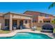 View of a refreshing pool with outdoor seating and a covered patio, perfect for enjoying the Arizona sunshine at 26072 N 74Th Ave, Peoria, AZ 85383
