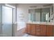 Well-lit bathroom with double vanities, a separate shower, and a tub, providing ample space and functionality at 26072 N 74Th Ave, Peoria, AZ 85383