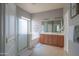 Bright bathroom featuring double sinks, a soaking tub, and a separate shower for a spa-like experience at 26072 N 74Th Ave, Peoria, AZ 85383