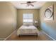 Cozy bedroom featuring natural light, soft carpet, and a stylish painting, creating a calming retreat at 26072 N 74Th Ave, Peoria, AZ 85383