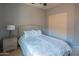 Comfortable bedroom with plush carpeting, a ceiling fan, and ample closet space, offering a relaxing private sanctuary at 26072 N 74Th Ave, Peoria, AZ 85383