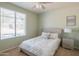 This bedroom features a neutral color palette and a large window for natural light at 26072 N 74Th Ave, Peoria, AZ 85383