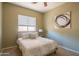 Bright bedroom featuring a ceiling fan, soft carpet, and a stylish painting, creating a calming retreat at 26072 N 74Th Ave, Peoria, AZ 85383