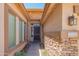 Inviting home entrance with stone accents, a secure screen door, and a clear view of the house number at 26072 N 74Th Ave, Peoria, AZ 85383