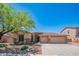 Beautiful single-story home featuring a well-maintained front yard, desert landscaping and a 3-car garage at 26072 N 74Th Ave, Peoria, AZ 85383