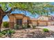 Charming single-story home with a xeriscaped yard, mature tree and an attached three-car garage at 26072 N 74Th Ave, Peoria, AZ 85383