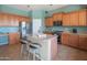 A bright kitchen featuring stainless steel appliances, a kitchen island, and barstool seating at 26072 N 74Th Ave, Peoria, AZ 85383