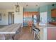 Open kitchen with a spacious island, barstool seating, and adjacent dining area at 26072 N 74Th Ave, Peoria, AZ 85383