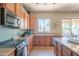 View of kitchen with wood cabinetry, stainless steel appliances and natural light at 26072 N 74Th Ave, Peoria, AZ 85383
