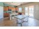 Bright kitchen with island and barstool seating, and an adjacent dining table and clear chairs at 26072 N 74Th Ave, Peoria, AZ 85383