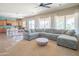 Inviting living room showcasing a large sectional sofa, open layout, and view of the modern kitchen at 26072 N 74Th Ave, Peoria, AZ 85383