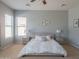 A well-lit main bedroom with a ceiling fan, windows with blinds, neutral decor and carpet flooring at 26072 N 74Th Ave, Peoria, AZ 85383