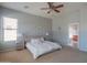 Spacious main bedroom featuring neutral decor, a ceiling fan, and carpeted floors at 26072 N 74Th Ave, Peoria, AZ 85383