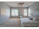 Spacious main bedroom with large windows, a ceiling fan, and plush carpeting, offering serene backyard views at 26072 N 74Th Ave, Peoria, AZ 85383