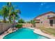 Tranquil pool area with mature landscaping and rock features, perfect for relaxation at 26072 N 74Th Ave, Peoria, AZ 85383