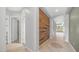 Inviting entryway featuring a custom wood accent wall and tile flooring, leading into the home's living spaces at 26135 N Desert Mesa Dr, Surprise, AZ 85387