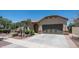 Charming single-story home with a two-car garage and beautiful xeriscape landscaping and brick-paved driveway at 26135 N Desert Mesa Dr, Surprise, AZ 85387