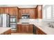 Gourmet kitchen features built-in stainless appliances, gas cooktop and wood cabinetry at 26135 N Desert Mesa Dr, Surprise, AZ 85387