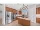 Stylish kitchen equipped with stainless steel appliances, a kitchen island, and custom cabinets for a modern aesthetic at 26135 N Desert Mesa Dr, Surprise, AZ 85387